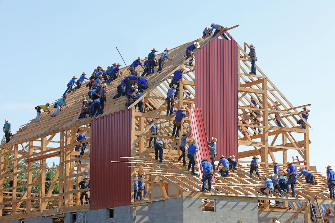 workers building the wooden structure of a house