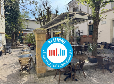 alumni logo over a courtyard picture
