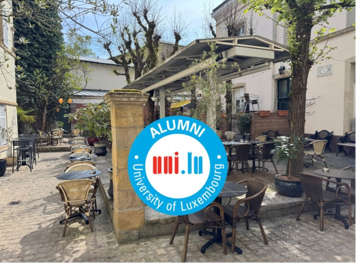 alumni logo over a courtyard picture
